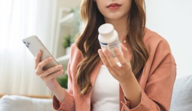 Health care asian young woman using smart phone for reading, searching prescription on bottle medicine, pill label text about information online, instructions side effects, pharmacy medicament concept