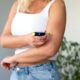 Semaglutide woman suffering from sugar diabetes giving semaglutide injection in shoulder at home using pen