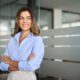 Happy confident mature professional business woman standing at work in office arms crossed looking away, proud hispanic middle aged businesswoman leader executive thinking of future success. Sermorelin for women: hormone balance, sleep, and skin health.