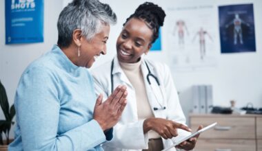 Black woman, doctor and elderly patient with good news, tablet and results for health, advice and report. Happy african medic, mobile touchscreen or healthcare with smile, tech or support in hospital
