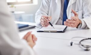 Doctor reviewing medical notes with a patient, discussing whether liraglutide and semaglutide can be taken together safely.