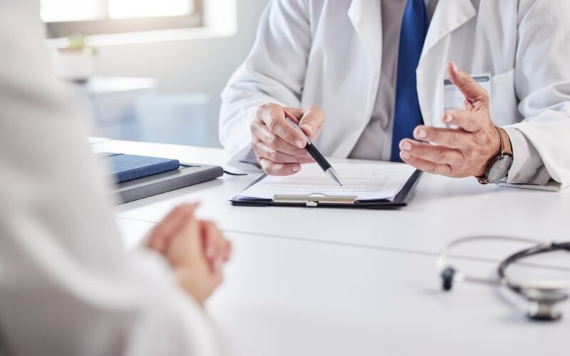 Doctor reviewing medical notes with a patient, discussing whether liraglutide and semaglutide can be taken together safely.