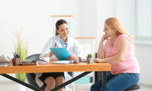 Doctor reviewing treatment notes with a patient during consultation, explaining the similarities and differences of liraglutide and Ozempic.