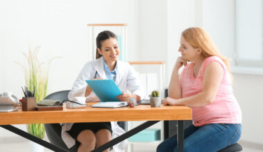 Doctor reviewing treatment notes with a patient during consultation, explaining the similarities and differences of liraglutide and Ozempic.