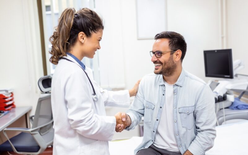 Wegovy smiling young female doctor shake hand close health insurance deal with elderly patient at consultation in hospital. Happy woman GP handshake greeting get acquainted with man in clinic.