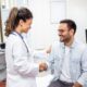 Wegovy smiling young female doctor shake hand close health insurance deal with elderly patient at consultation in hospital. Happy woman GP handshake greeting get acquainted with man in clinic.