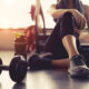 Woman tirzepatide exercise workout in gym fitness breaking relax holding apple fruit after training sport with dumbbell and protein shake bottle healthy lifestyle bodybuilding, Athlete builder muscles lifestyle.