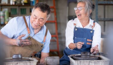 An older couple smiling and laughing while working with clay at a pottery wheel, symbolizing creativity, vitality, and healthy aging supported by NAD+ therapy.