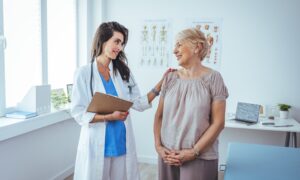 Smiling caring young female Wegovy nurse doctor caretaker assisting happy senior grandma helping old patient in rehabilitation recovery at medical checkup visit, elder people healthcare homecare concept
