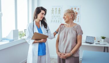 Smiling caring young female Wegovy nurse doctor caretaker assisting happy senior grandma helping old patient in rehabilitation recovery at medical checkup visit, elder people healthcare homecare concept