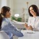 Woman discussing NAD+ IV therapy with a clinician, learning about session pricing, treatment plans, and potential benefits of NAD+ therapy for energy, recovery, and wellness.