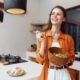 Woman enjoying a healthy salad as part of preparing for an NAD+ IV therapy session, highlighting the importance of light, balanced meals and proper nutrition before infusion for better energy and comfort.