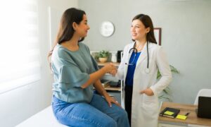 Woman on Wegovy weight loss medication consulting with her doctor about symptoms of fatigue.