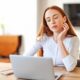 “Woman at home using a laptop, representing the convenience and accessibility of consulting a PCOS online doctor for faster diagnosis and personalized care.