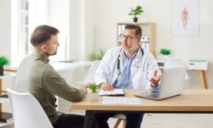 Doctor consulting with a patient in a bright medical office, representing professional guidance on combining Metformin and GLP-1 medications like semaglutide or tirzepatide for improved weight loss outcomes.