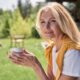 Confident middle-aged woman enjoying coffee outdoors, symbolizing balance and well-being during menopause, representing the discussion on GLP-1 medications and hormone replacement therapy (HRT) for weight management in women over 50.