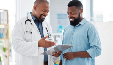 Smiling doctor discusses a treatment plan with a patient while reviewing a medical chart together in a bright clinic — representing supportive healthcare guidance and transparent discussion about medication costs.