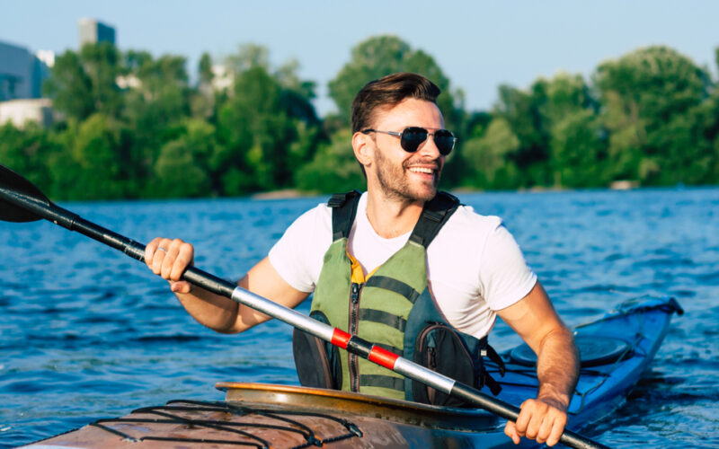 “Energetic, healthy man kayaking, representing the benefits of IV therapy for hydration, energy, and overall wellness support.