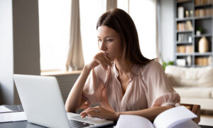 Focused woman researching on a laptop at home, representing someone exploring clinical updates and FDA timelines for new weight loss medications like retatrutide.