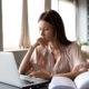 Focused woman researching on a laptop at home, representing someone exploring clinical updates and FDA timelines for new weight loss medications like retatrutide.