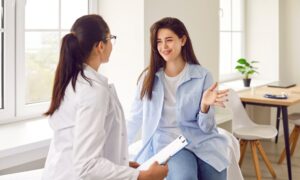Happy woman talking to her doctor about transistioning from Semaglutide to Tirzepatide in a bright, realxing room