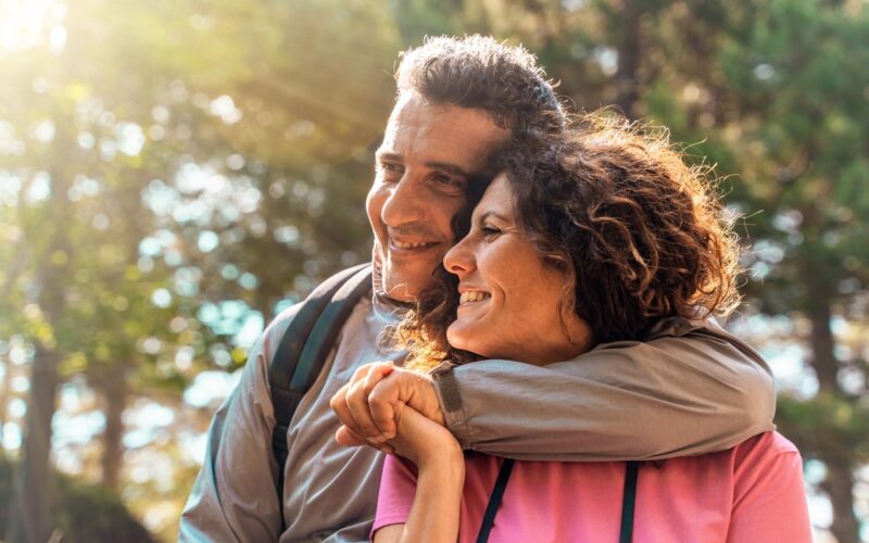 A couple on wegovy experiencing affected libido as a side effect hiking on a nature trail