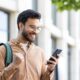 A smiling man outdoors looks excited while checking his phone, celebrating good news — representing successfully accessing a Zepbound discount or savings card.
