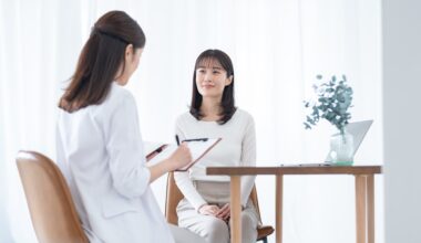 A woman sits across from a healthcare provider during a consultation in a bright, modern clinic, symbolizing professional hormone testing and personalized guidance for interpreting DUTCH test results.
