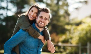 A couple in nature on semaglutide hugging each other experiencing affected sex drive as a side effect.