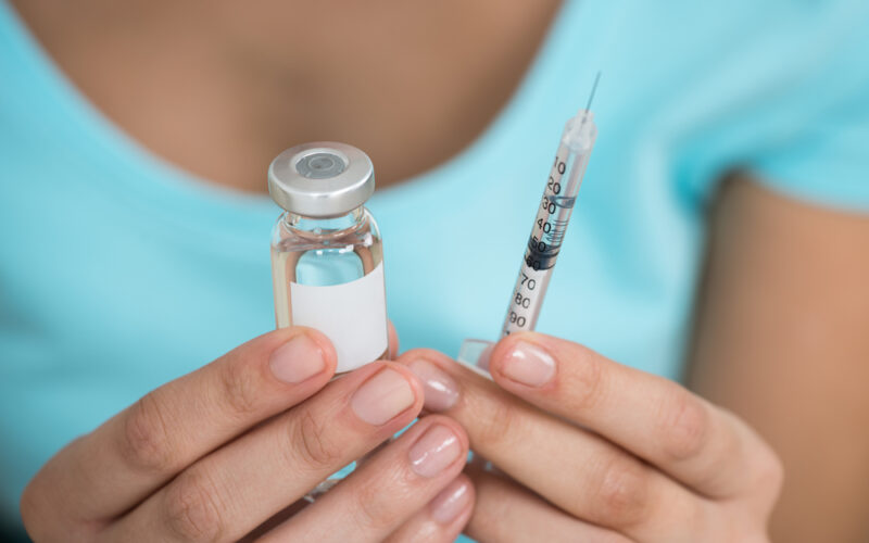 Person holding Wegovy needle and enjection learning how to properly store and use their weight loss medication correctly