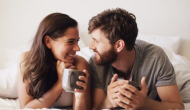 Smiling couple lying together in bed, representing intimacy and sexual health topics related to zepbound, weight loss, and sex drive changes.
