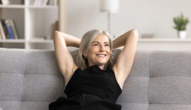 Happy woman relaxed on couch enjoying the benefits microdosing methylene blue for subtle cognitive, mood, and energy-related enhancements.