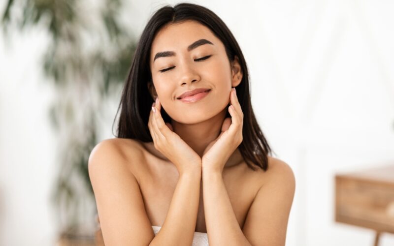 Woman with clear, glowing skin representing the benefits of skin peptides like GHK-Cu and TB-500