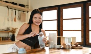 Woman Making Herself A Protein Smoothie Drink After Learning Why Low Protein Diets Make Weight Loss So Much Harder