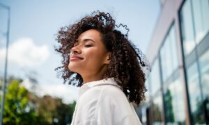 Woman happy and peaceful after seeking support for hormonal balance through peptide therapy. Oxytocin, PCOS Support & Perimenopause Care.