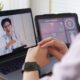 Person having a telehealth video consultation with a doctor on a laptop, representing mental health evaluation, anxiety and mood disorder testing, and accessing lab tests without long wait times.