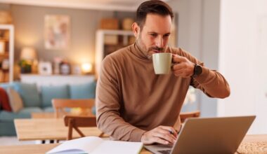 Man working on a laptop at home while drinking coffee, representing early-stage Mounjaro (tirzepatide) weight loss progress and lifestyle changes during the first three months of treatment.