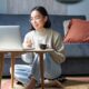 A woman sitting at home uses a laptop for an online healthcare consultation while researching medication options, representing telehealth and Ozempic alternatives.