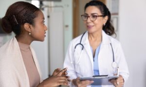 Doctor discussing Mounjaro (tirzepatide) dosing options with a patient during a clinical visit, representing guidance on dose escalation, safety, and personalized weight loss or diabetes treatment.