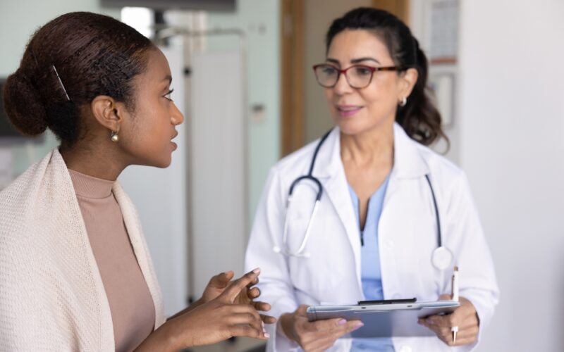 Doctor discussing Mounjaro (tirzepatide) dosing options with a patient during a clinical visit, representing guidance on dose escalation, safety, and personalized weight loss or diabetes treatment.