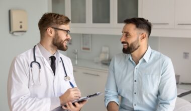 A doctor talking with a male patient during a first weight loss lab visit, discussing symptoms and lab testing.