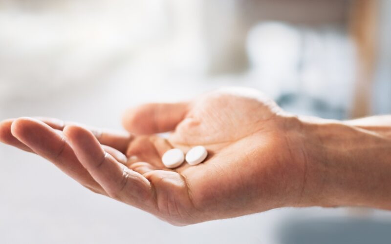 A person holding their pills. They are in the process of increasing their dose for their Wegovy pill