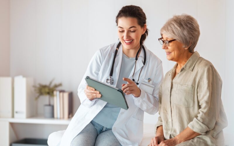 Doctor speaking to a patient. They are explaining longevity treatments and how they work.