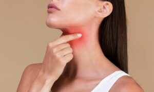 Woman feeling her neck. Worried about thyroid cancer