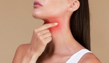 Woman feeling her neck. Worried about thyroid cancer