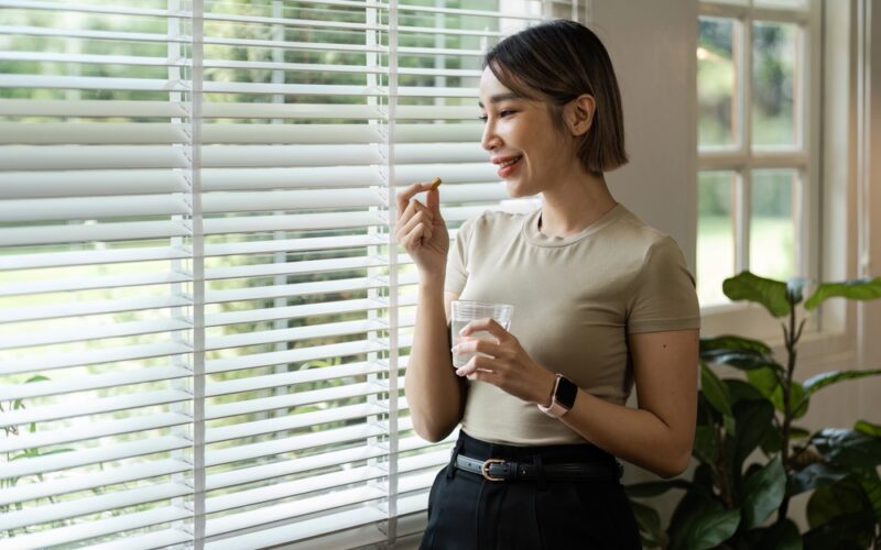 Young woman hand holding medical pill. Taking the glutathione pill as a supplement
