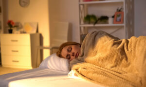 A woman getting a good nights rest when using NAD+ for improved sleep benefits.