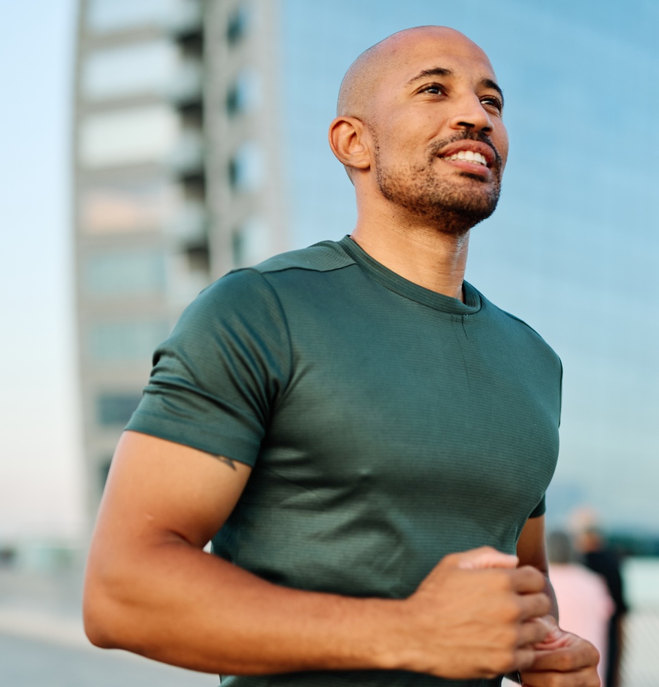 A healthy men going on a jog after getting their physicial performance back through TRT while being aware of how it affects their fertility.