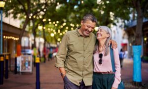 An older couple walking after boosting their metabolism through NAD+ therapy and medication.